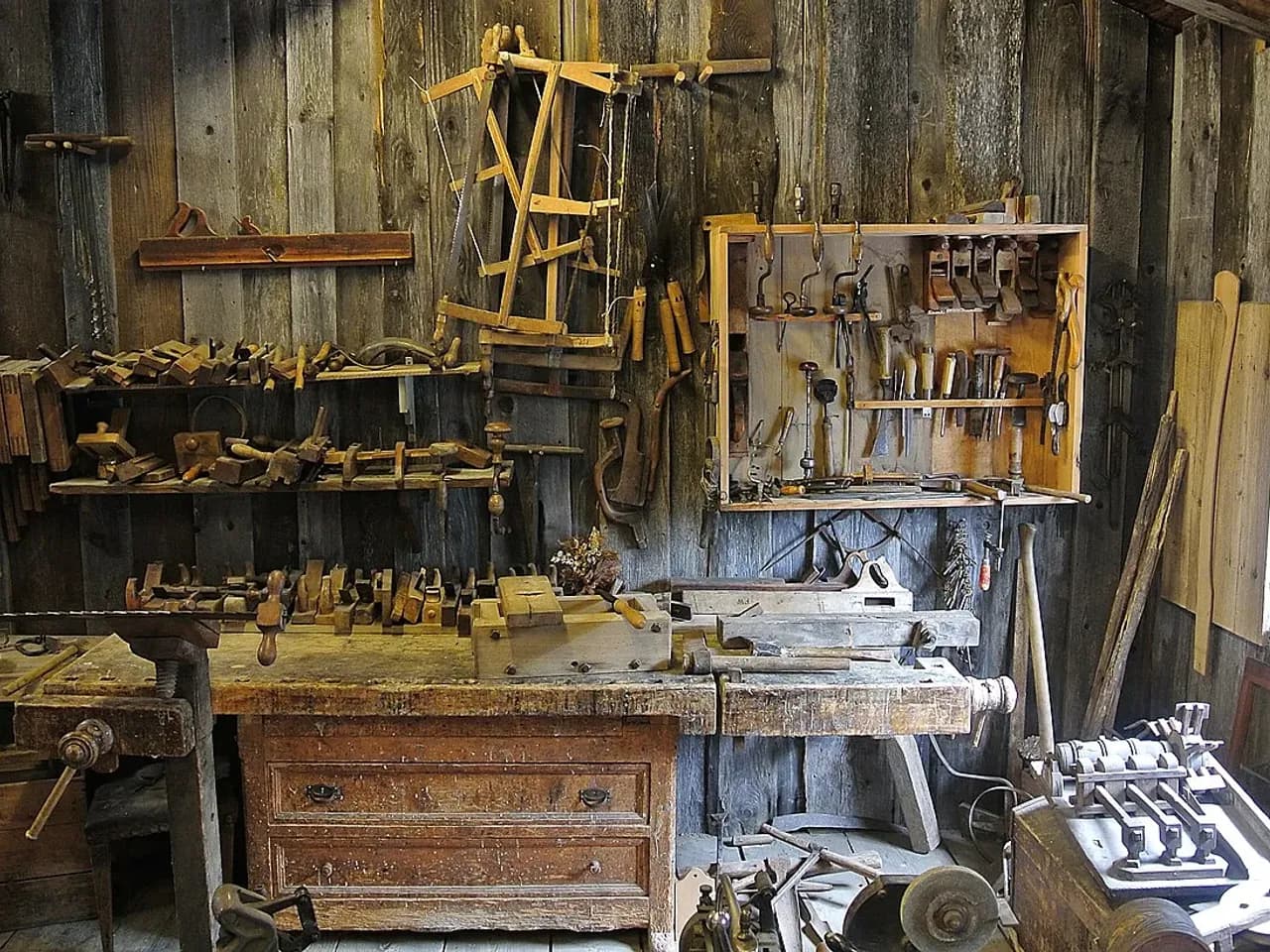 Atelier de menuiserie, avec ses établis et ses outils, illustrant le travail des artisans