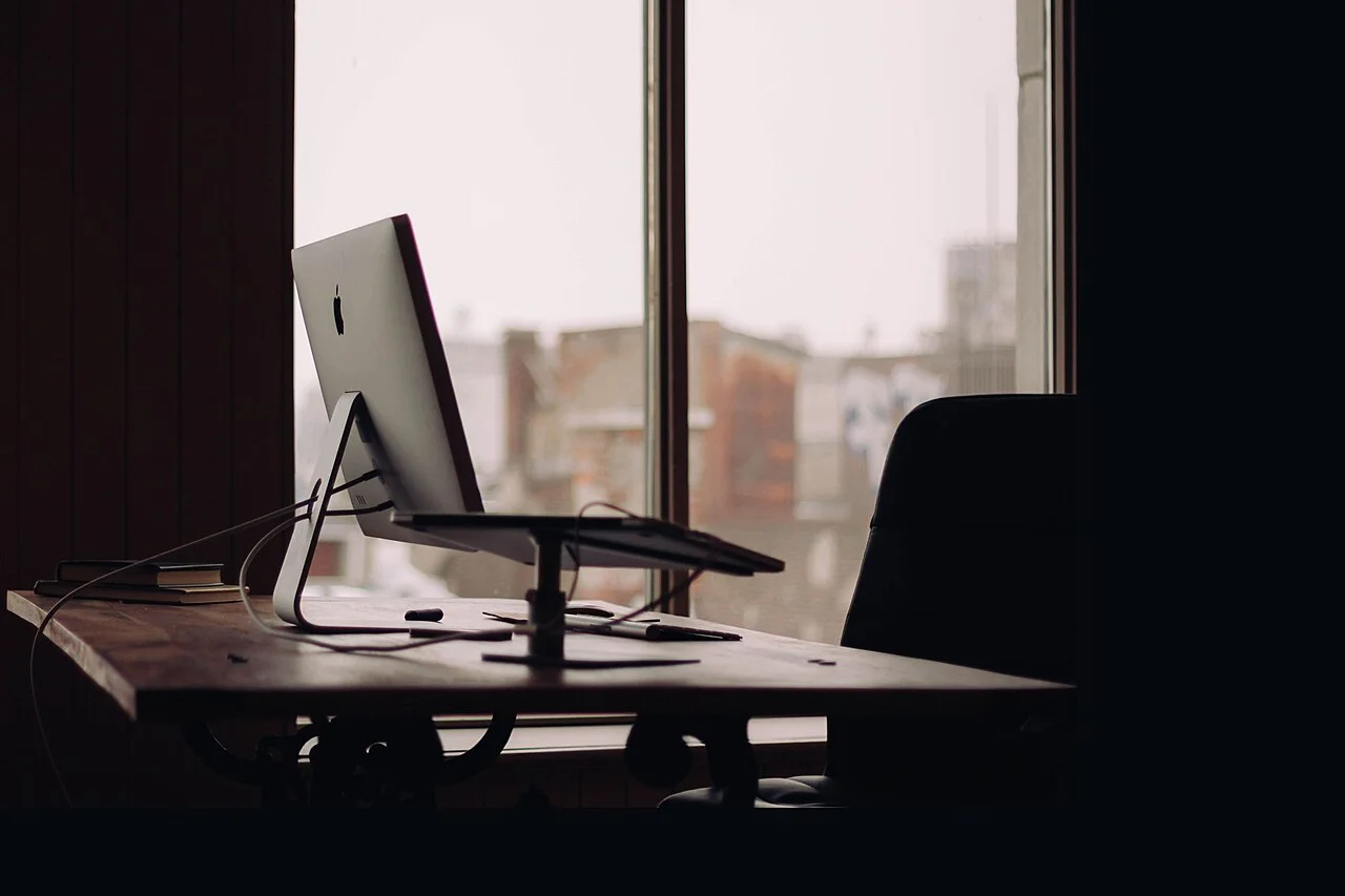 Bureau et écran installés devant une fenêtre
